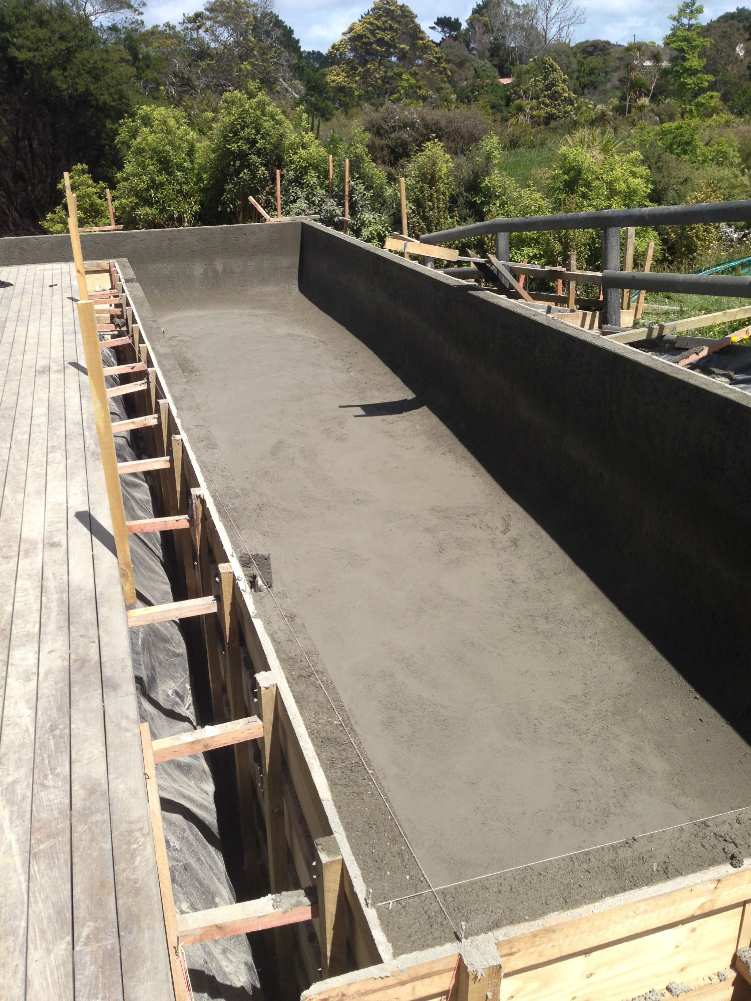 Concrete swimming pool with wood boxing still on
